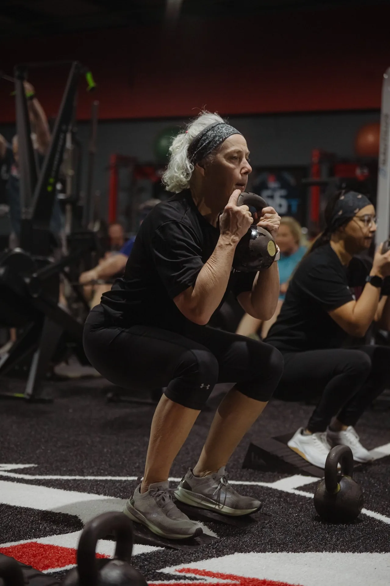 Woman doing kettlebell goblet squat at BCI gym